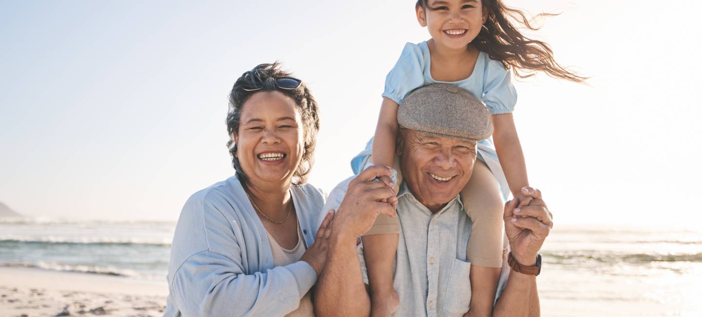 Happy, beach and portrait of girl with her grandparents on a tropical family vacation or adventure. Smile, sunset and kid bonding with her grandmother and grandfather by the ocean on holiday together