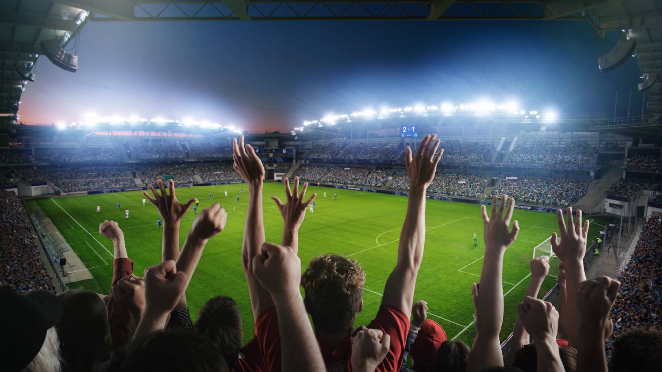 Establishing Shot of Fans Cheer for Their Team on a Stadium During Soccer Championship Match.
