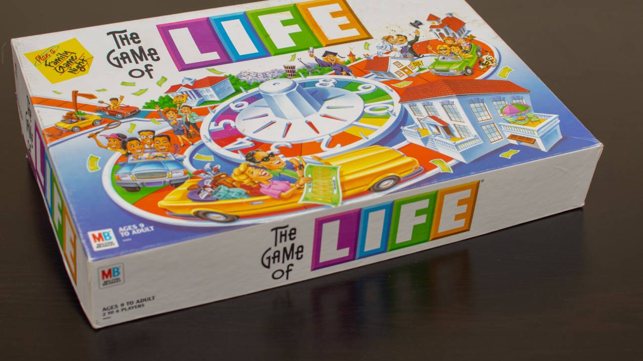 A board game on a table the board game is called the game of life