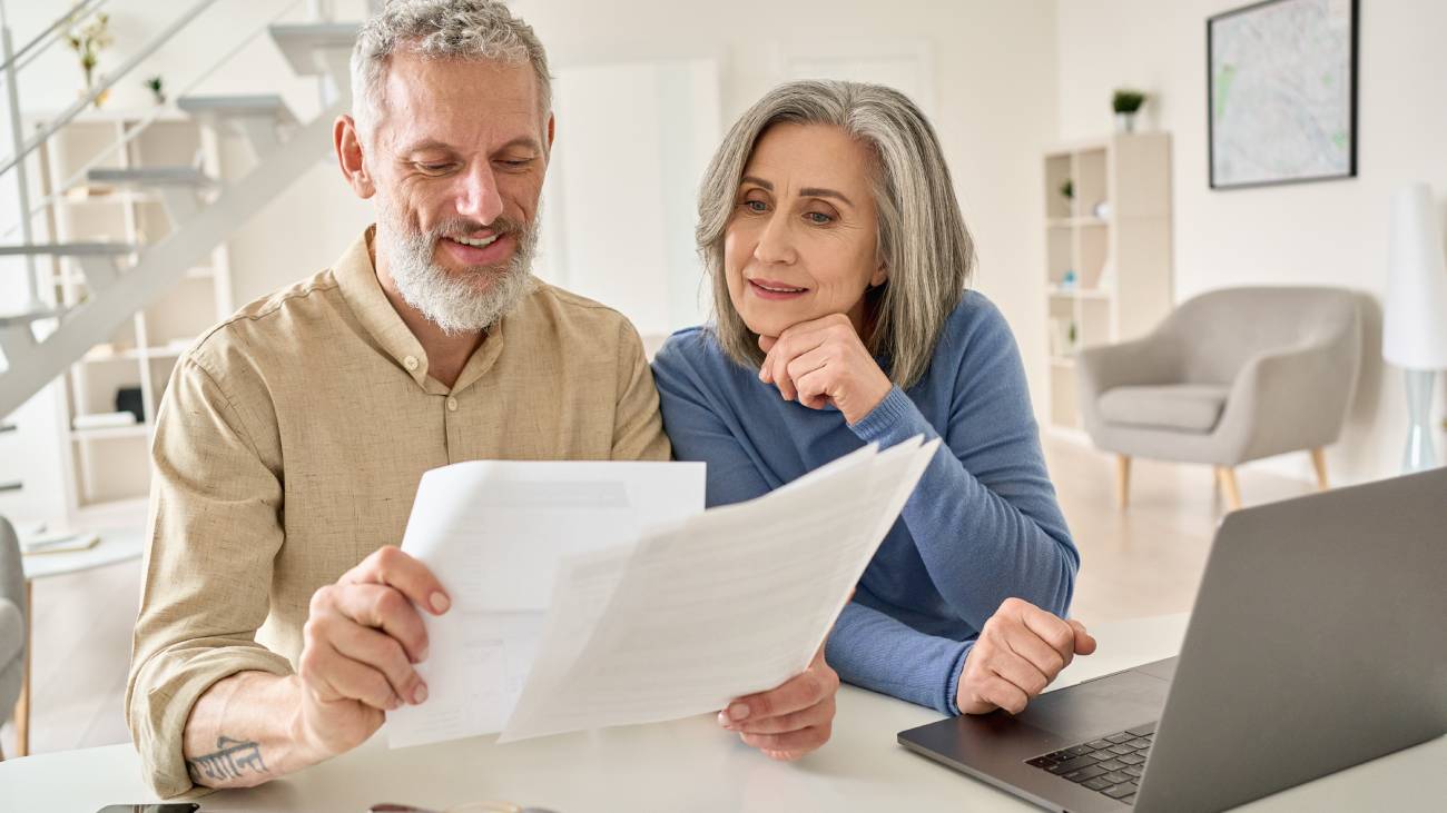 mature married couple reviewing paper work