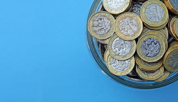 Pound coins in a cup