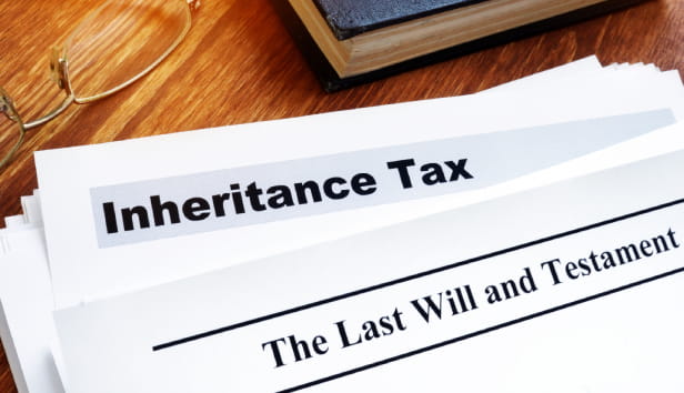 Inheritance tax and last will on the desk.