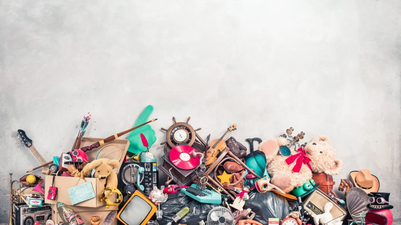 A large pile of music memorabilia including guitars and radios