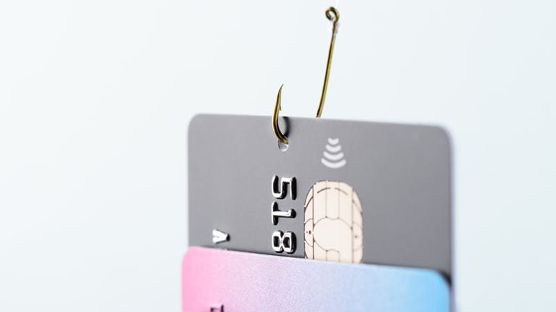 A debit card hanging on a hook