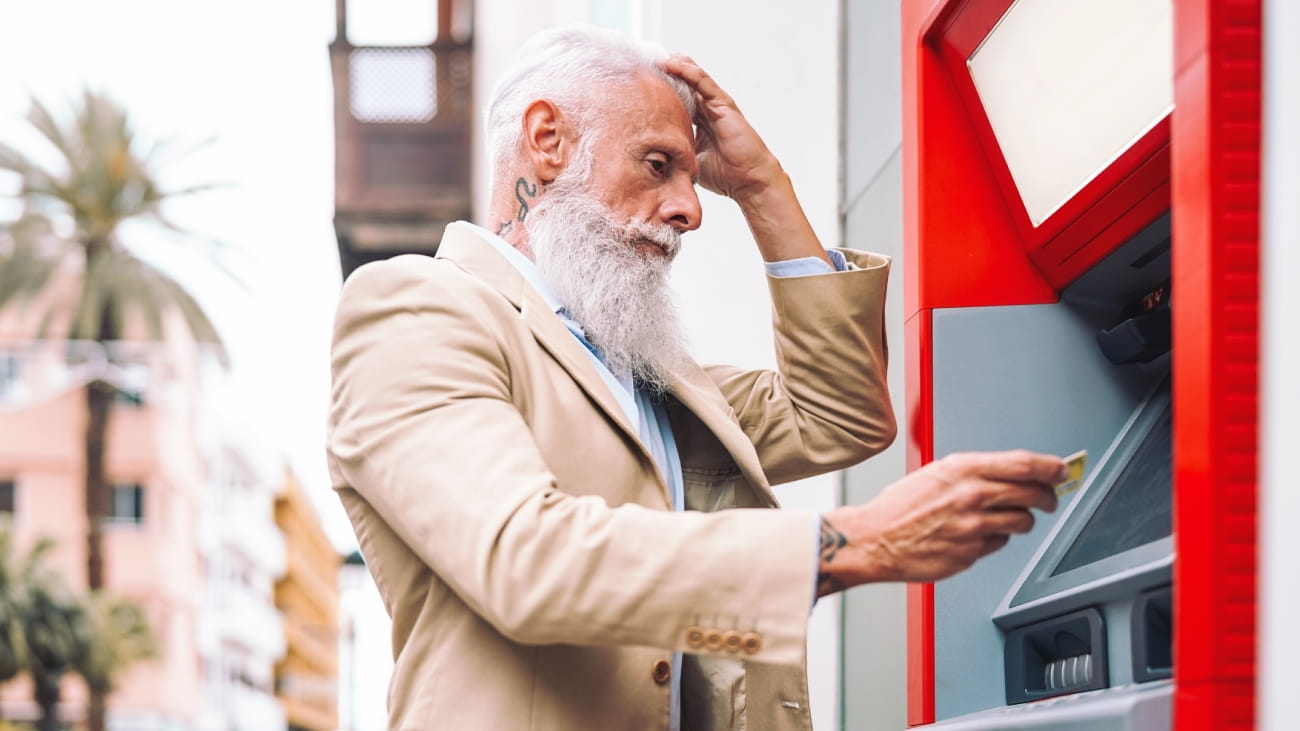A man putting his card in an ATM machine