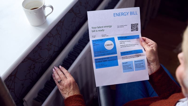 A person sat reading their energy bill
