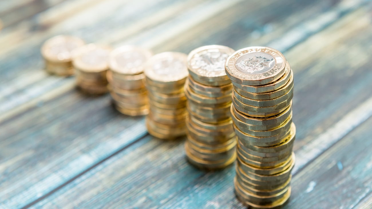 Pound coins stacked up next to one another
