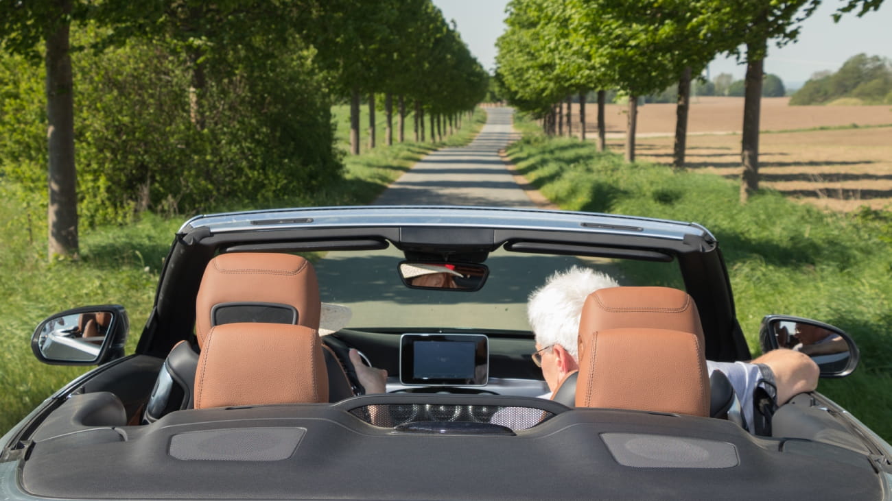 Senior couple in sports car on a sunny day