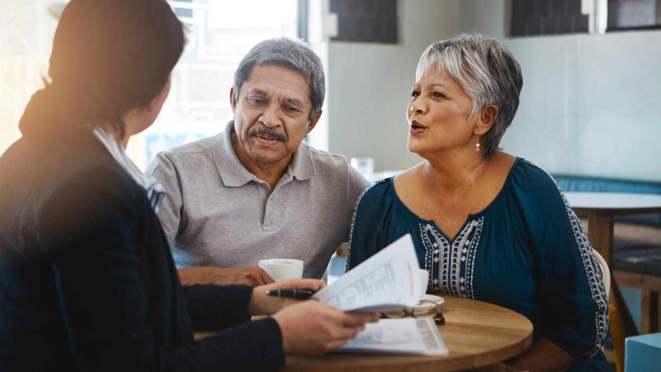 Senior couple, talking and lawyer with documents for financial advice, retirement plan and will at home. Old man, elderly woman and attorney with paperwork, budget negotiation and legal agreement