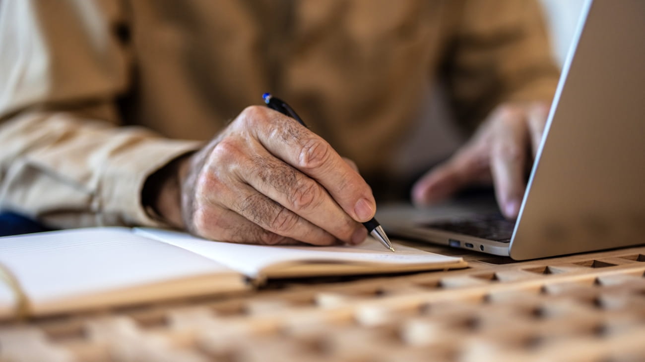 Finance, retirement and old man with paperwork, laptop and budget plan, checking investment and taxes. Mortgage, insurance document and online pension savings review, senior man with debt in home.