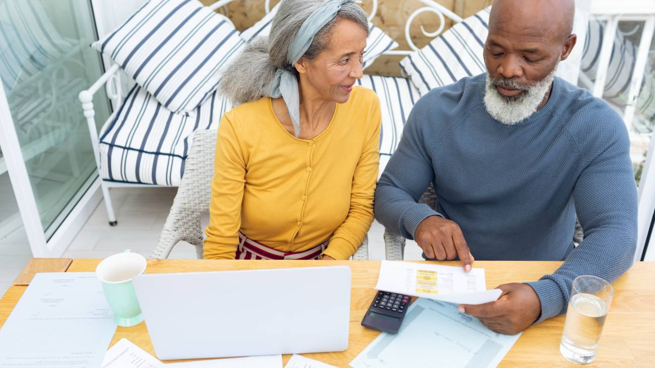 Front view of mature Couple calculating finances.