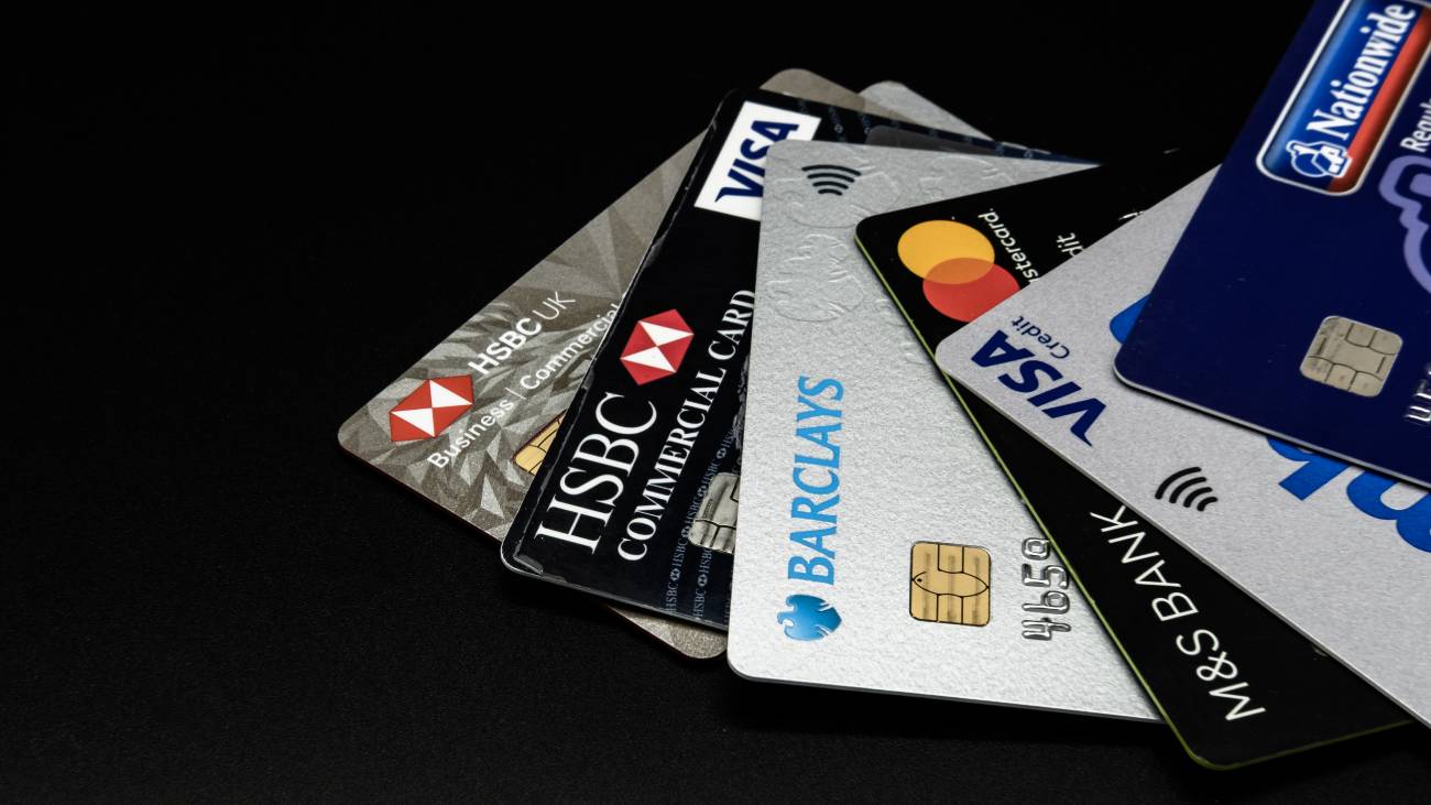 Detailed view of a selection of credit and debit cards from well-known banking and finance companies.