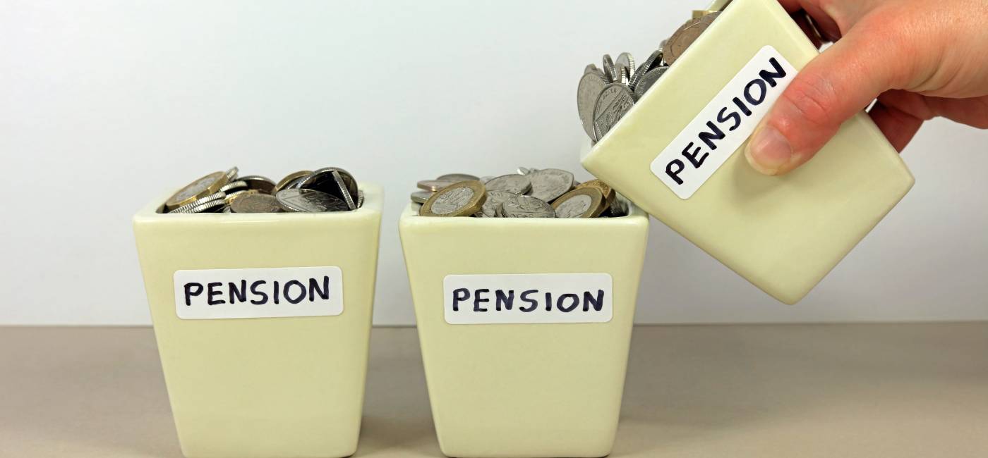 A hand tipping a pension pot in to another. 