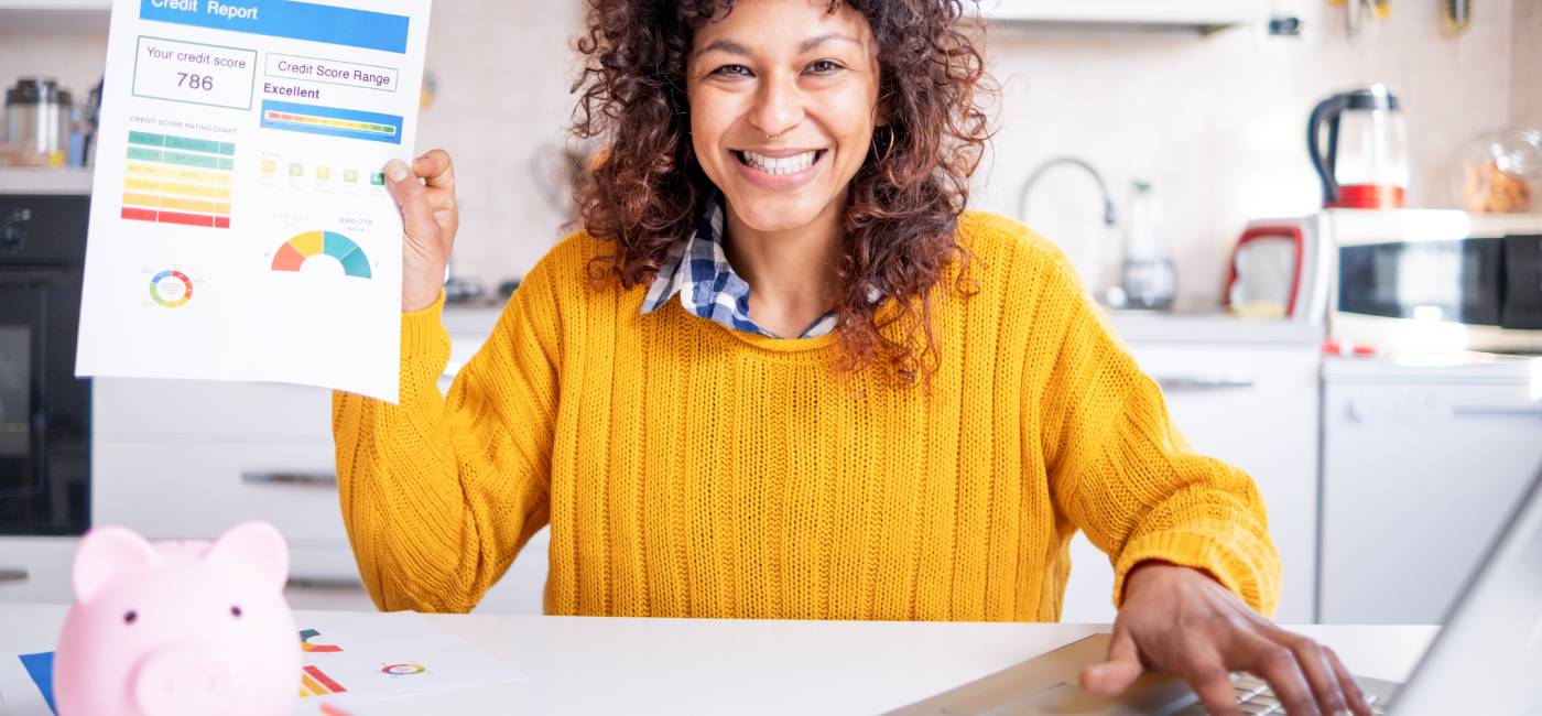 happy woman smiling while checking her good credit score online