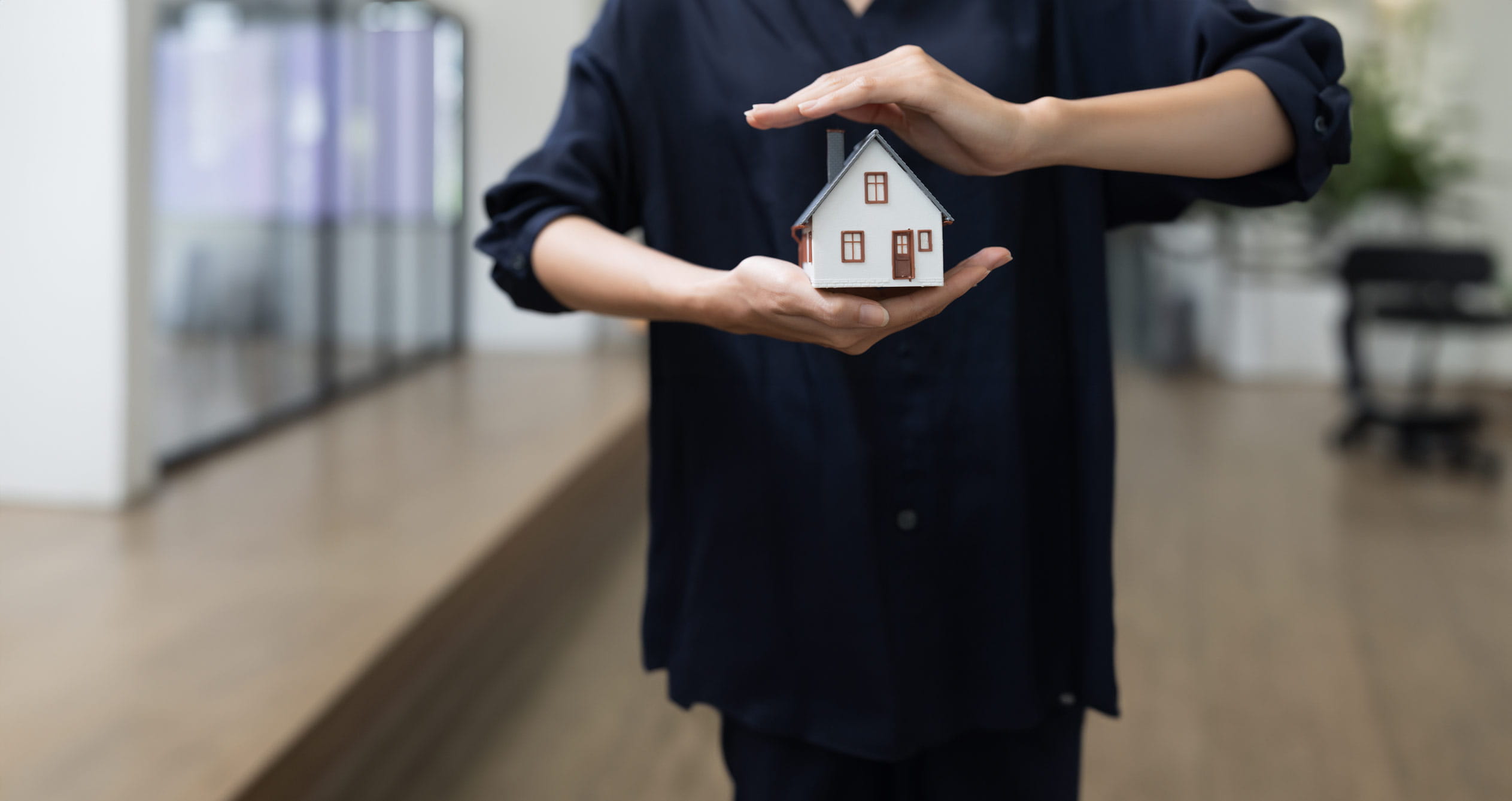 A man holding a house in his hand