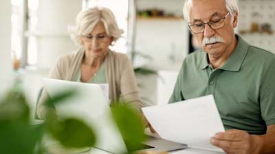 A mature couple looking through papers