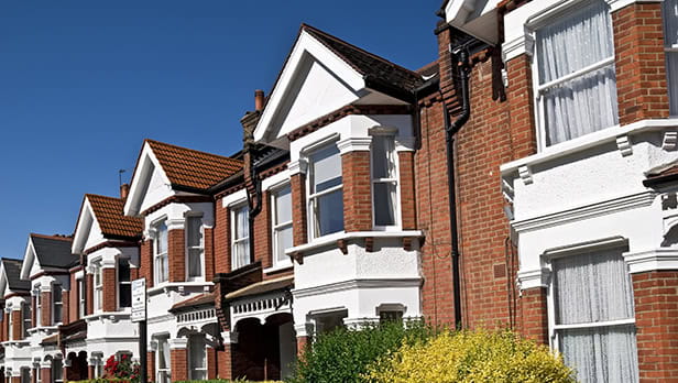 A row of houses on a blue sky day