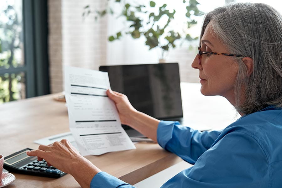 A woman sat at a desk looking at paperwork