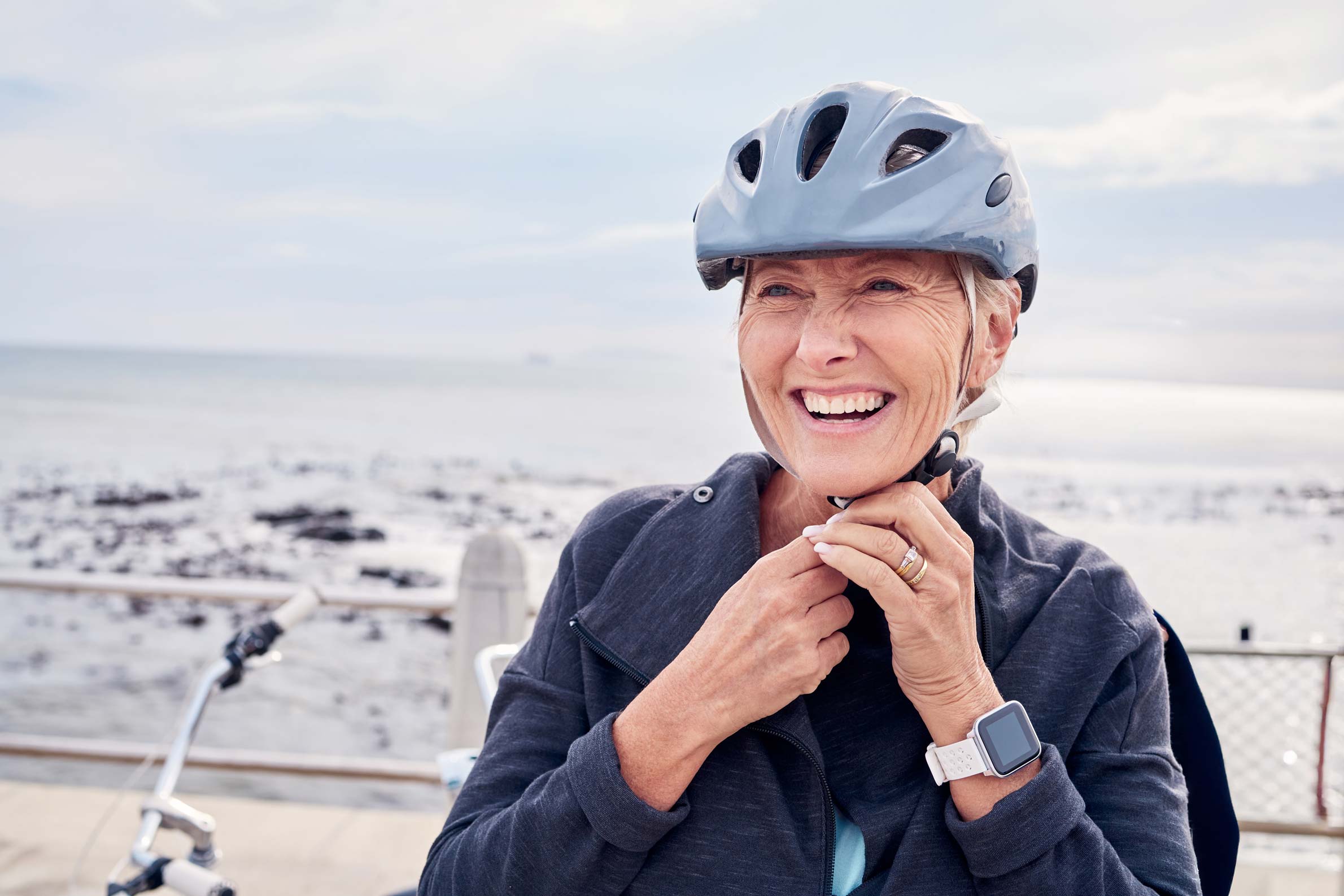 A female cyclist on the promenade by the beach