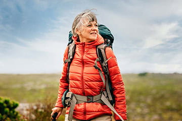 A female hiker out walking across the moors on a bright blue sky day